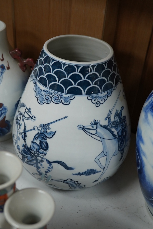 Three blue and white Chinese porcelain vases, a similar jar and cover, plus three stacking jars and covers on stand, a large dragon designed charger on stand and a similar decorated vase, charger 39cm diameter (7). Condi